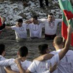 Bulgarians celebrate the devour of Epiphany with a custom dive into frosty rive