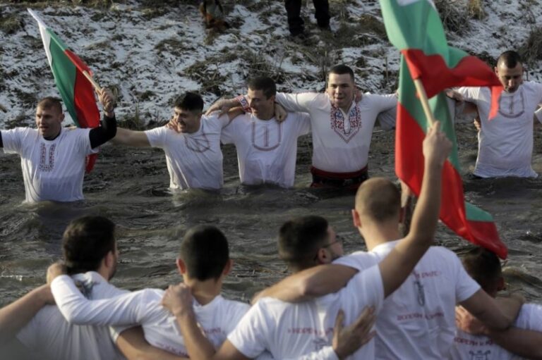 Bulgarians celebrate the devour of Epiphany with a custom dive into frosty rive