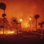 A moment wind-whipped fierce blaze is burning out of control in the Los Angeles area