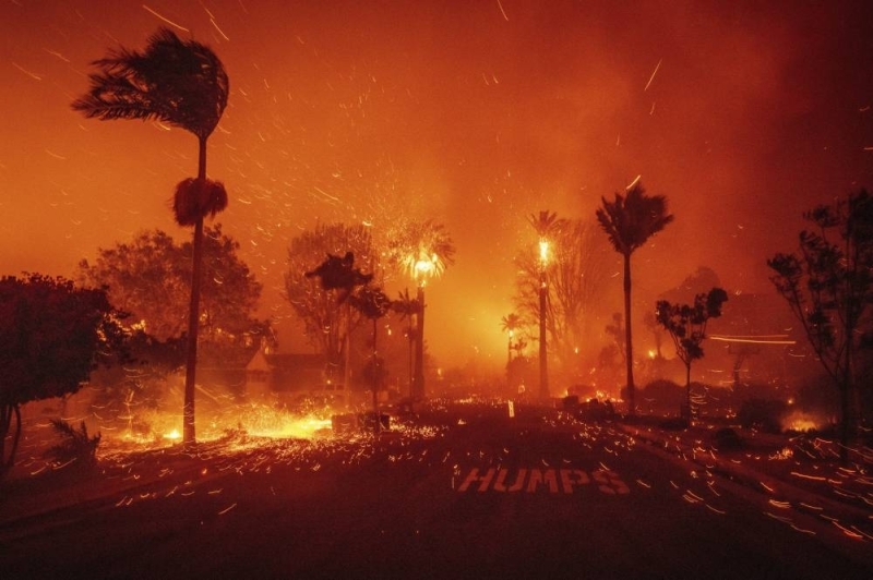 A moment wind-whipped fierce blaze is burning out of control in the Los Angeles area
